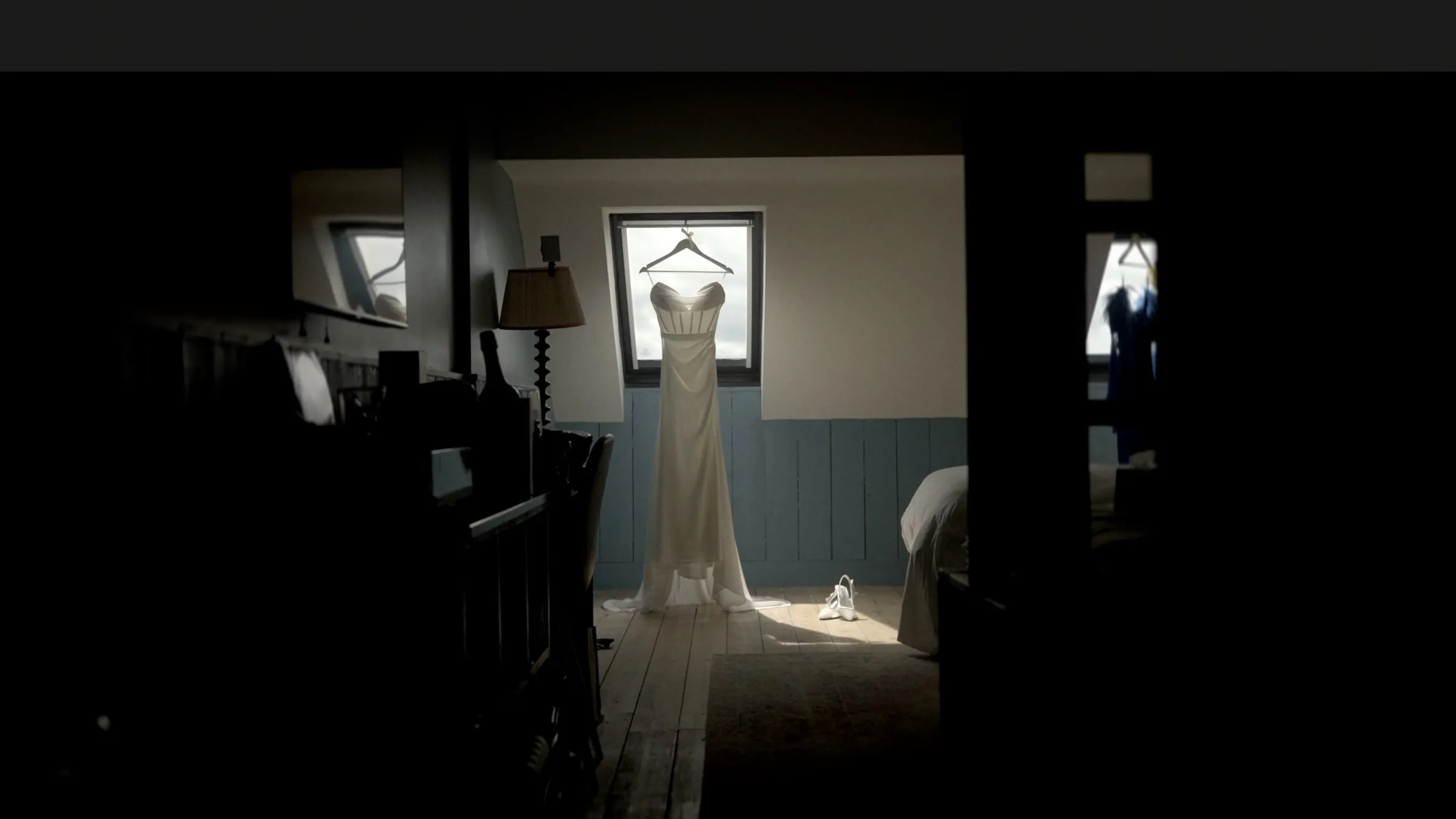 A wedding dress hanging in a lit doorway at Glasson Lakehouse